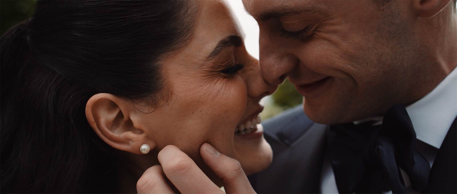 Smiling Wedding Couple Hold Each Other Close
