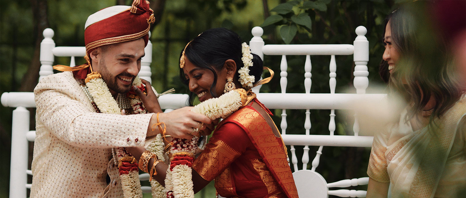 Hindu bride and groom exchange garlands during jayamala ceremony.