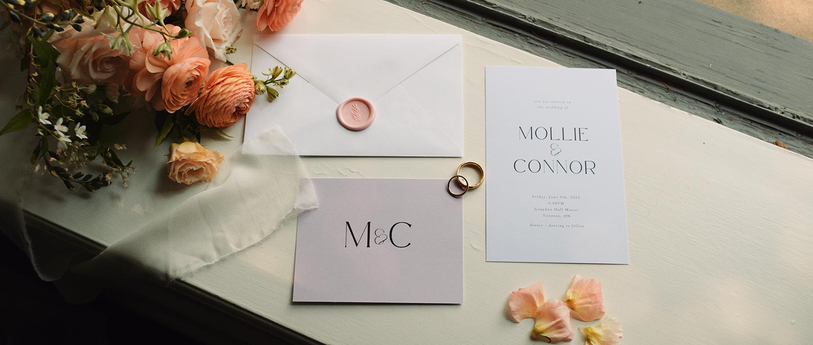 Mollie and Connor's wedding stationery details on a window sill at Graydon Hall Manor.