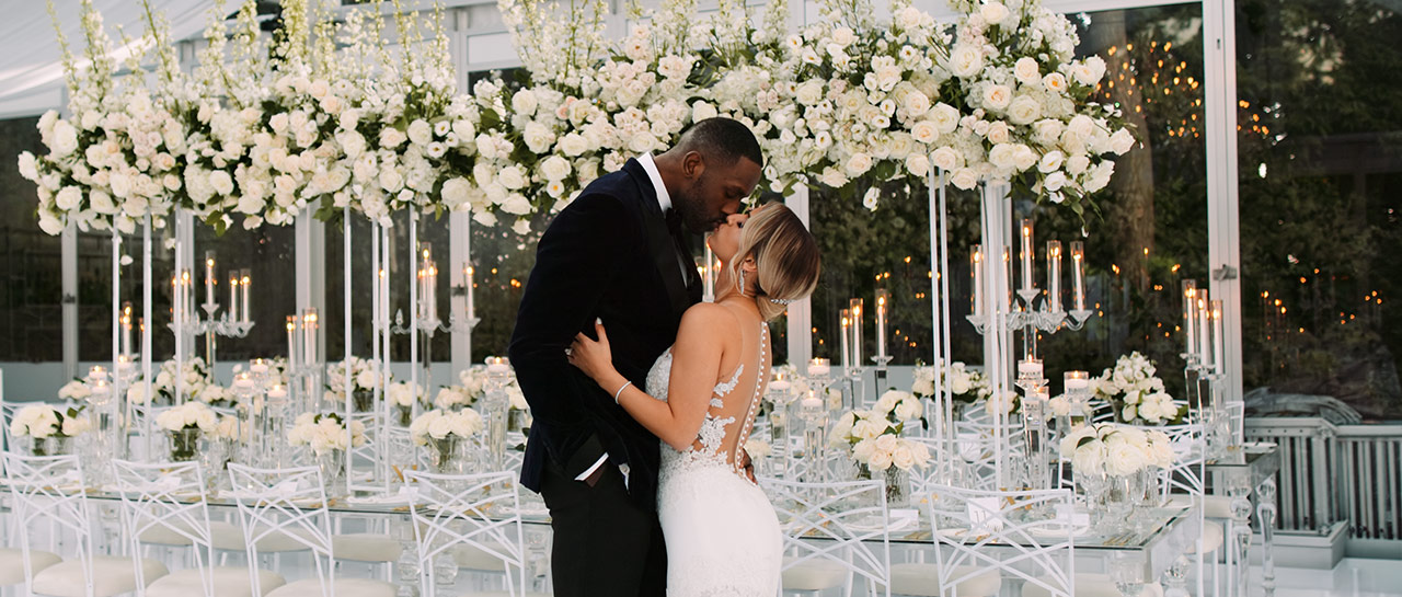 Sarah and Patrick Patterson standing in their all-white Casa Loma wedding reception